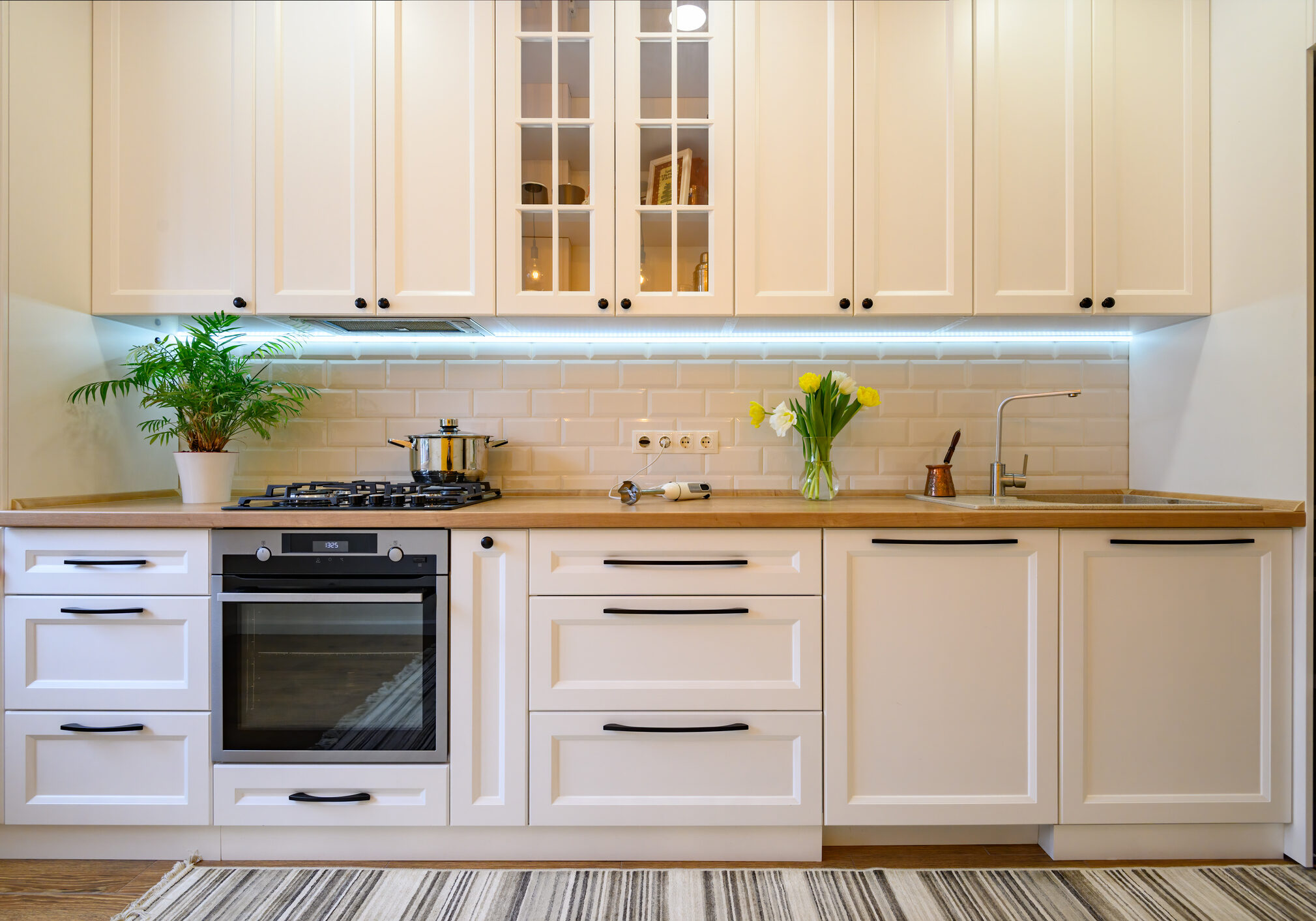 cozy well designed modern kitchen interior with appliances and dining table